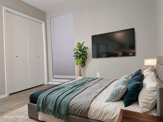 bedroom featuring a closet and wood finished floors