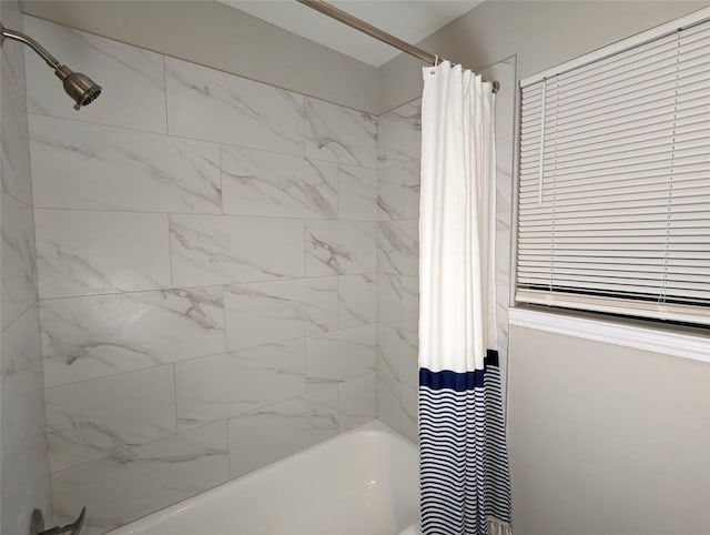 bathroom with shower / bath combo with shower curtain