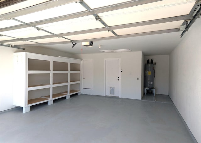 garage with a garage door opener and water heater