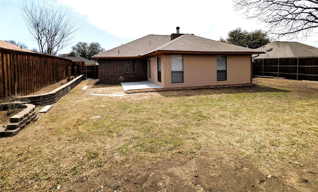 back of property featuring a patio area, a lawn, and a fenced backyard