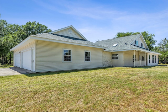 view of front of home with a front yard and concrete driveway