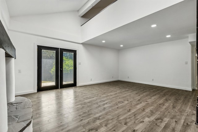 unfurnished living room featuring recessed lighting, high vaulted ceiling, baseboards, and wood finished floors