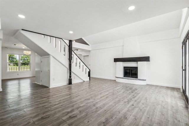 unfurnished living room featuring stairway, recessed lighting, and dark wood-style flooring