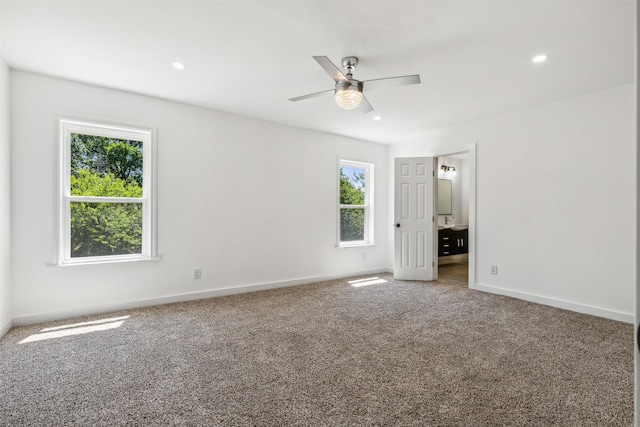 unfurnished bedroom with recessed lighting, multiple windows, baseboards, and carpet