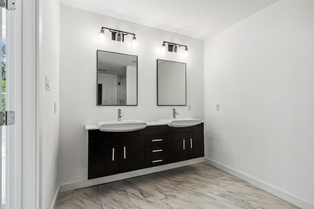 full bathroom with baseboards, marble finish floor, and a sink