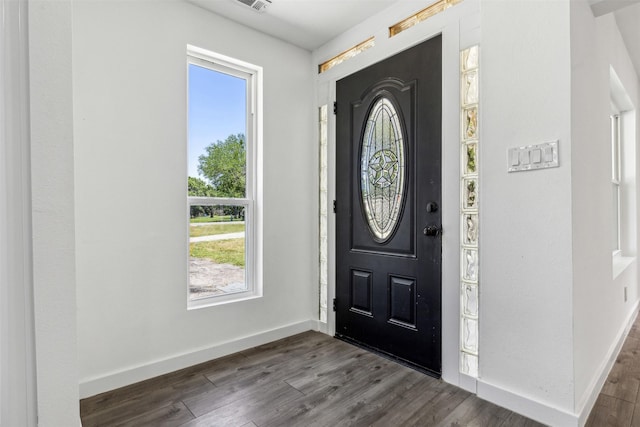 entryway with baseboards and dark wood finished floors