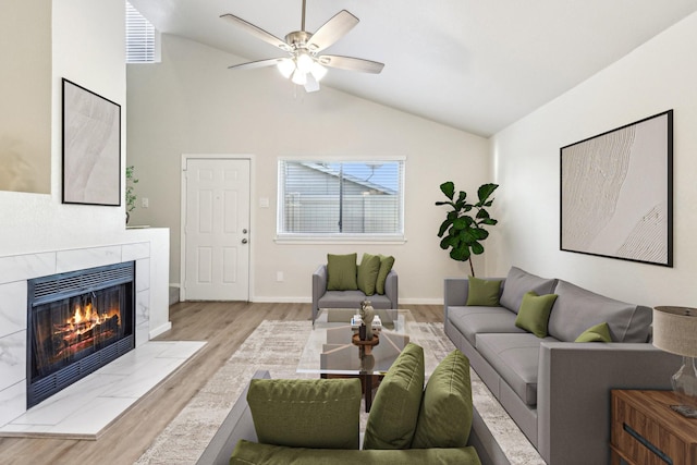 2240 Tarpley Rd Unit 451, Carrollton, TX 75006 - living area with wood finished floors, ceiling fan, a tile fireplace, baseboards, and high vaulted ceiling
