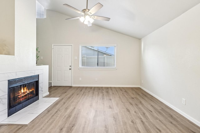 2240 Tarpley Rd Unit 451, Carrollton, TX 75006 - unfurnished living room with wood finished floors, a tile fireplace, ceiling fan, baseboards, and high vaulted ceiling