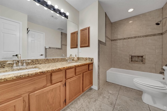 bathroom featuring a sink, toilet, double vanity, and tile patterned floors