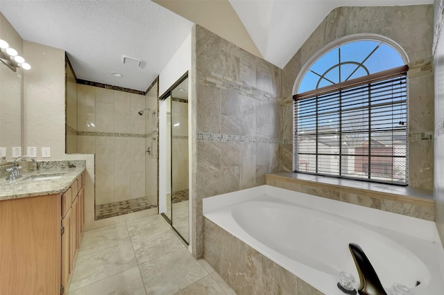 bathroom with a garden tub, plenty of natural light, a tile shower, and vaulted ceiling