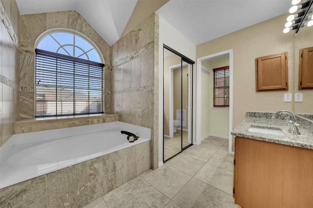 full bath with a garden tub, toilet, a healthy amount of sunlight, and vaulted ceiling