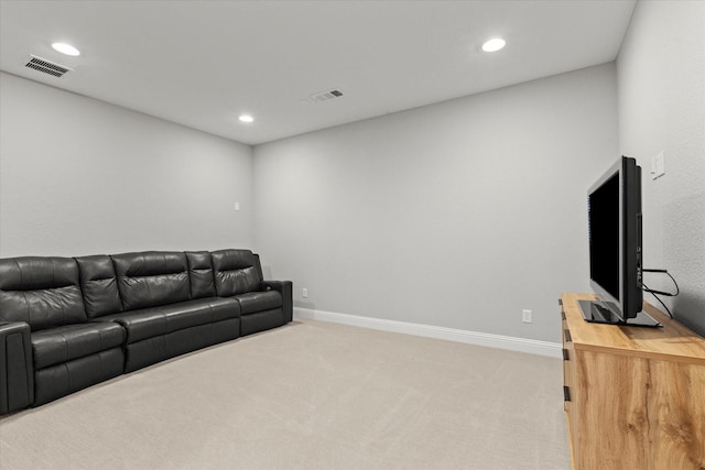 living room featuring visible vents, light carpet, and baseboards