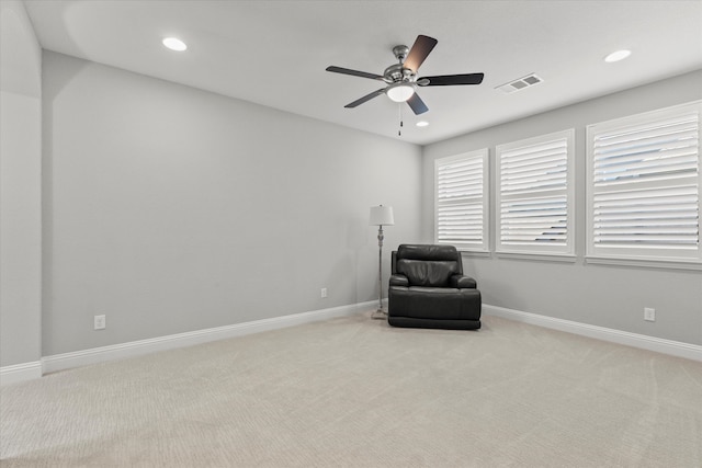 living area featuring recessed lighting, visible vents, light carpet, and baseboards