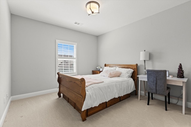 bedroom with visible vents, light colored carpet, and baseboards