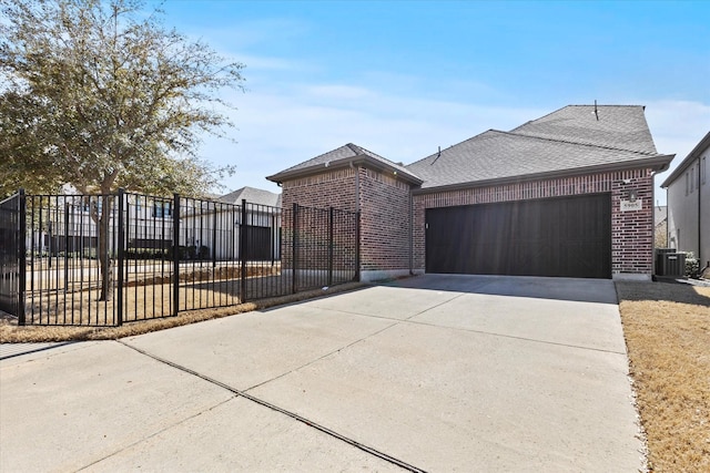 view of front of house featuring fence, driveway, a shingled roof, a garage, and brick siding