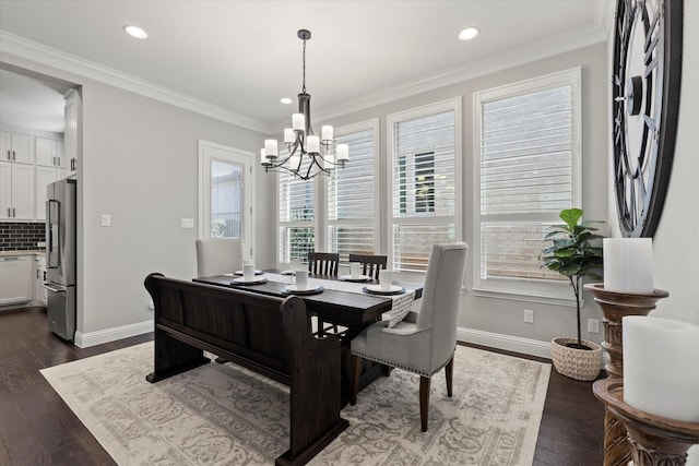 dining room with a notable chandelier, dark wood-type flooring, baseboards, and ornamental molding