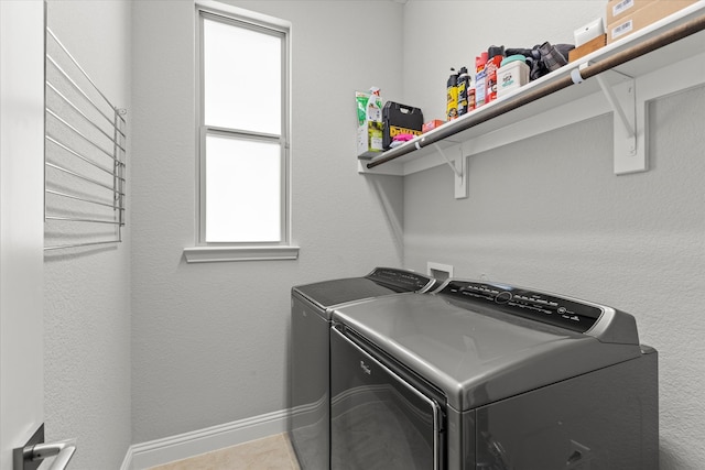 clothes washing area with laundry area, independent washer and dryer, and baseboards