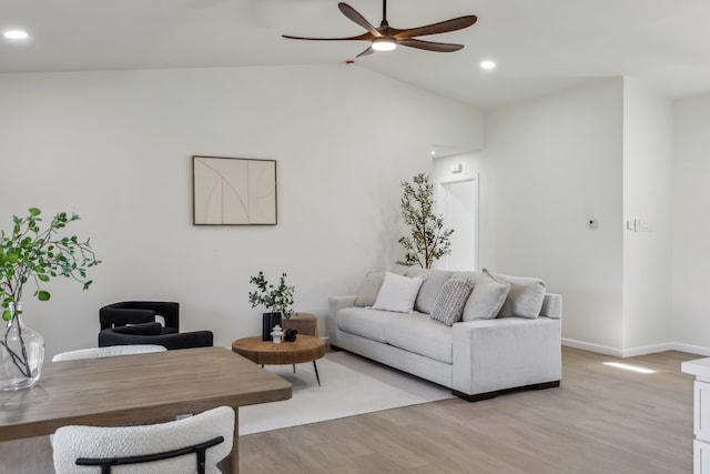 living area with baseboards, vaulted ceiling, recessed lighting, light wood-style floors, and a ceiling fan