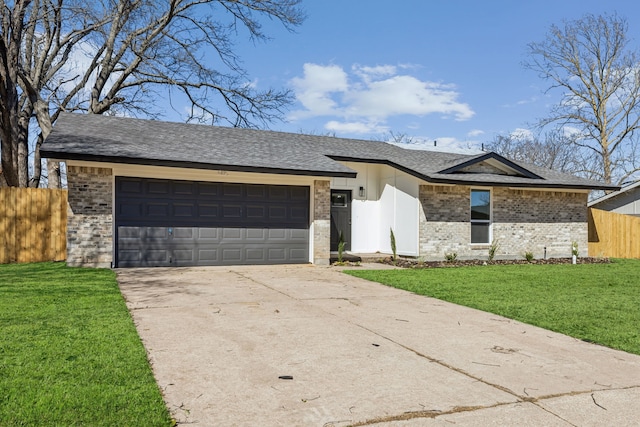 view of front of house with brick siding, concrete driveway, a front yard, and fence