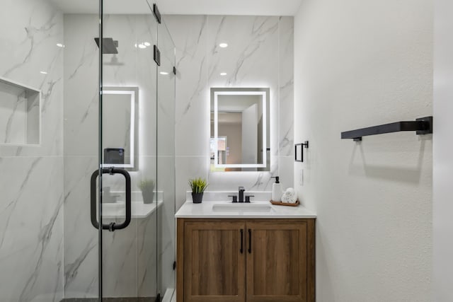 full bath featuring a marble finish shower, vanity, and tasteful backsplash