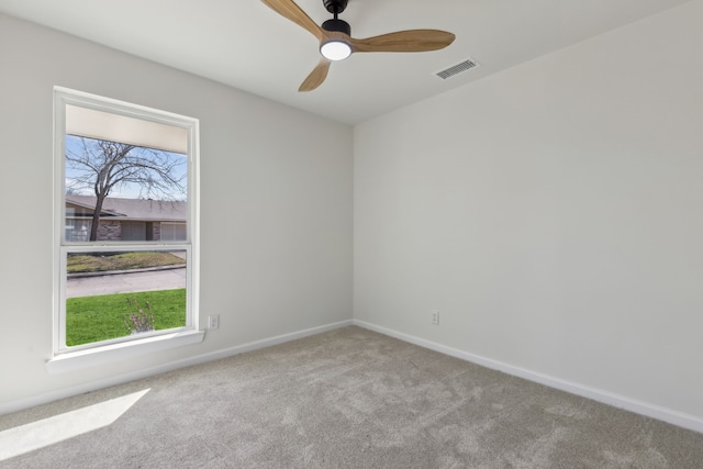 empty room featuring visible vents, baseboards, ceiling fan, and carpet flooring