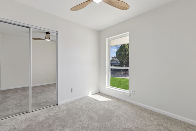 unfurnished bedroom with carpet flooring, multiple windows, and baseboards