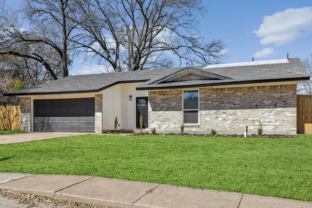 view of front of home with driveway, an attached garage, a front yard, and fence