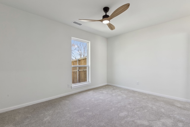 spare room featuring visible vents, baseboards, a ceiling fan, and carpet flooring