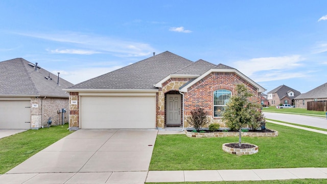 view of front of property with roof with shingles, an attached garage, a front lawn, concrete driveway, and brick siding