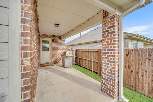 view of patio / terrace featuring fence and grilling area