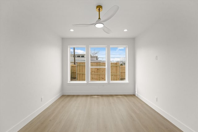 spare room with ceiling fan, baseboards, light wood-style flooring, and recessed lighting