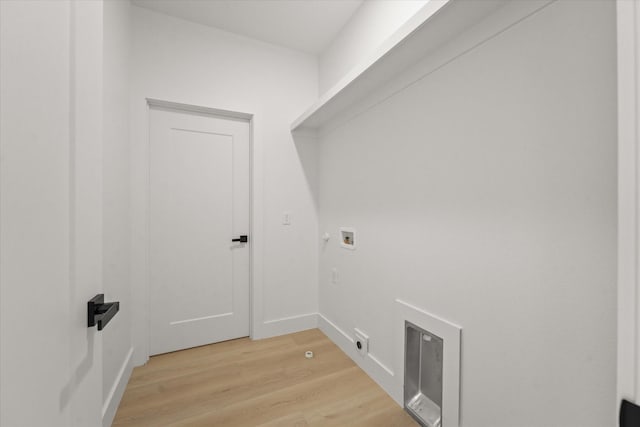 washroom featuring baseboards, laundry area, light wood-style flooring, washer hookup, and hookup for a gas dryer