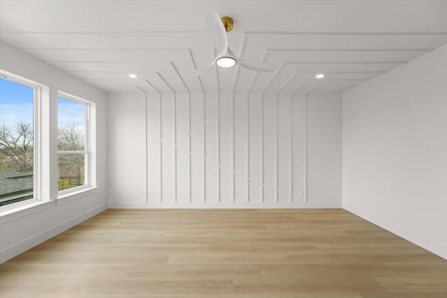 unfurnished room with light wood-type flooring and baseboards