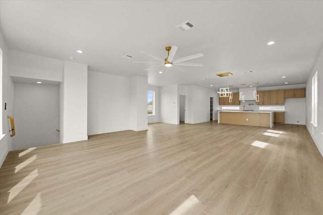 unfurnished living room featuring recessed lighting, a ceiling fan, visible vents, and light wood-type flooring