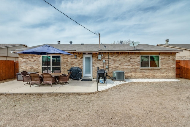 rear view of property featuring brick siding, central AC, and a patio area