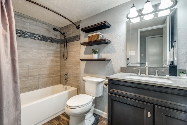 full bathroom featuring toilet, shower / bath combo, a textured wall, a textured ceiling, and vanity