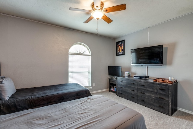 bedroom featuring baseboards, light carpet, and a ceiling fan