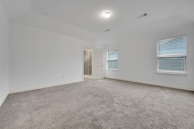 spare room with visible vents, carpet flooring, and baseboards