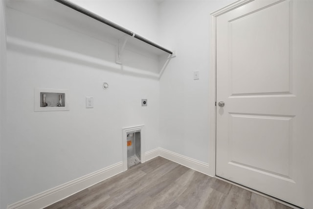 washroom featuring electric dryer hookup, wood finished floors, gas dryer hookup, hookup for a washing machine, and laundry area