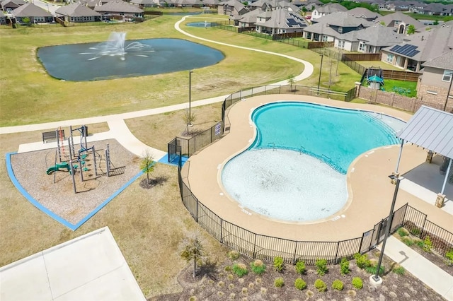 community pool with a residential view and fence