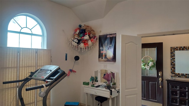 exercise area featuring vaulted ceiling