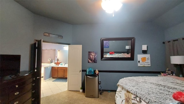 bedroom featuring light tile patterned flooring and connected bathroom