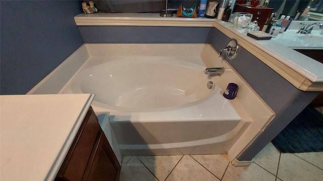 full bath featuring vanity, tile patterned floors, and a garden tub