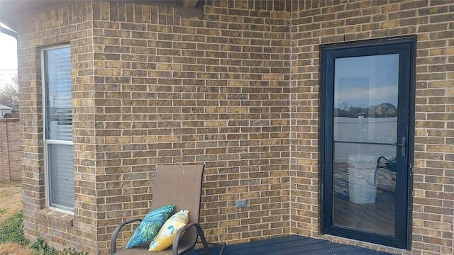 doorway to property with brick siding