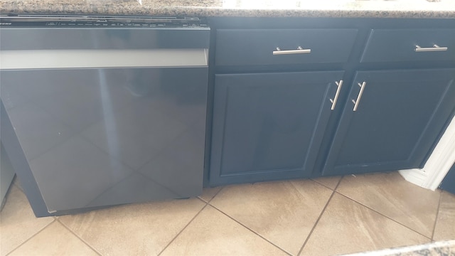 room details featuring blue cabinetry and stainless steel dishwasher