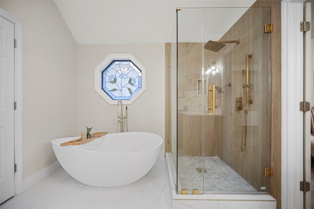 bathroom with baseboards, a soaking tub, marble finish floor, and a stall shower