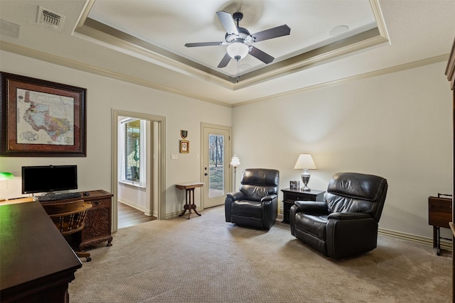 living area featuring a tray ceiling, visible vents, and carpet floors