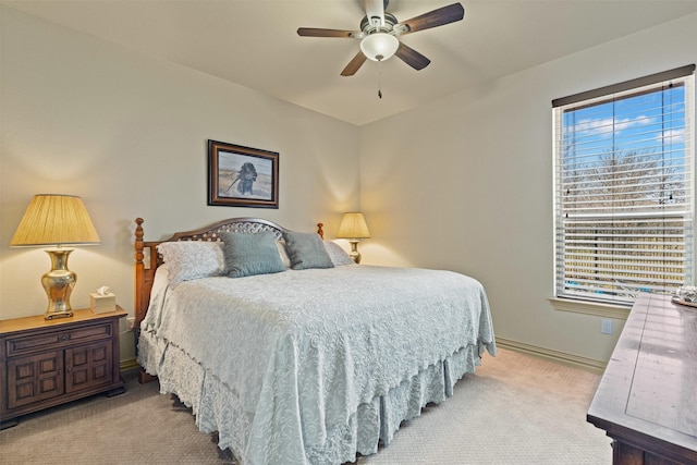 carpeted bedroom with a ceiling fan and baseboards