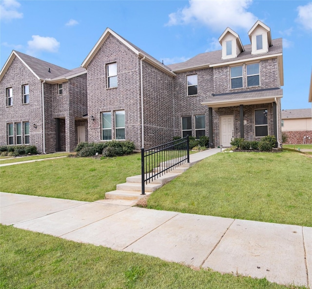 view of front of property with brick siding and a front lawn