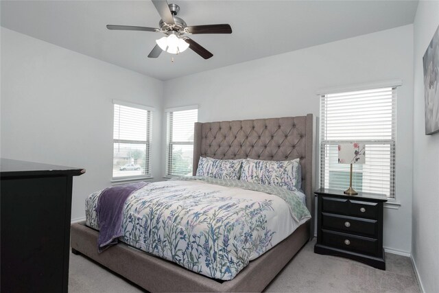 bedroom featuring baseboards, ceiling fan, and carpet flooring